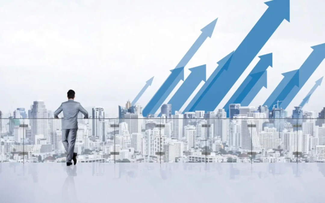 A person standing on a mountain peak at sunrise, symbolizing motivation and achieving goals.