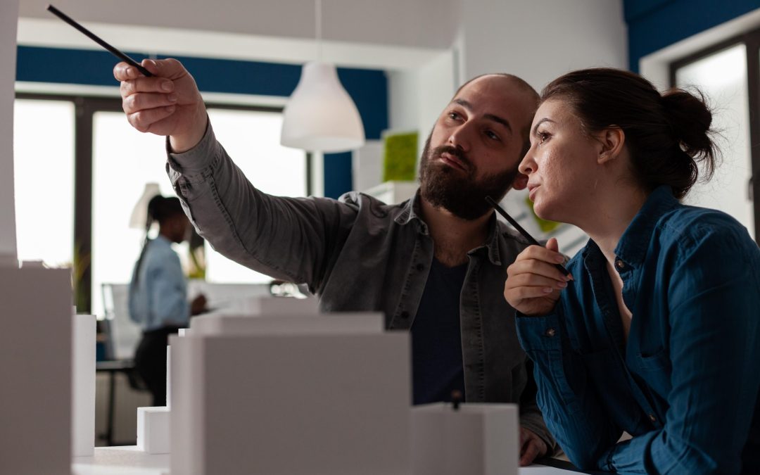 Architects collaborating on skyscraper design model