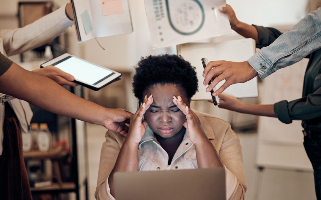 Stressed multitasking woman in office with documents and phone